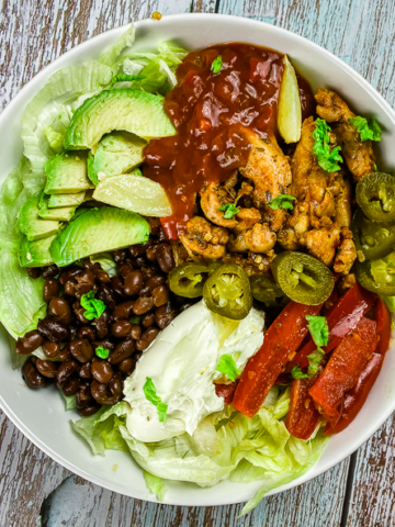 White Bowl with BBQ chicken, salad, beans and sour cream