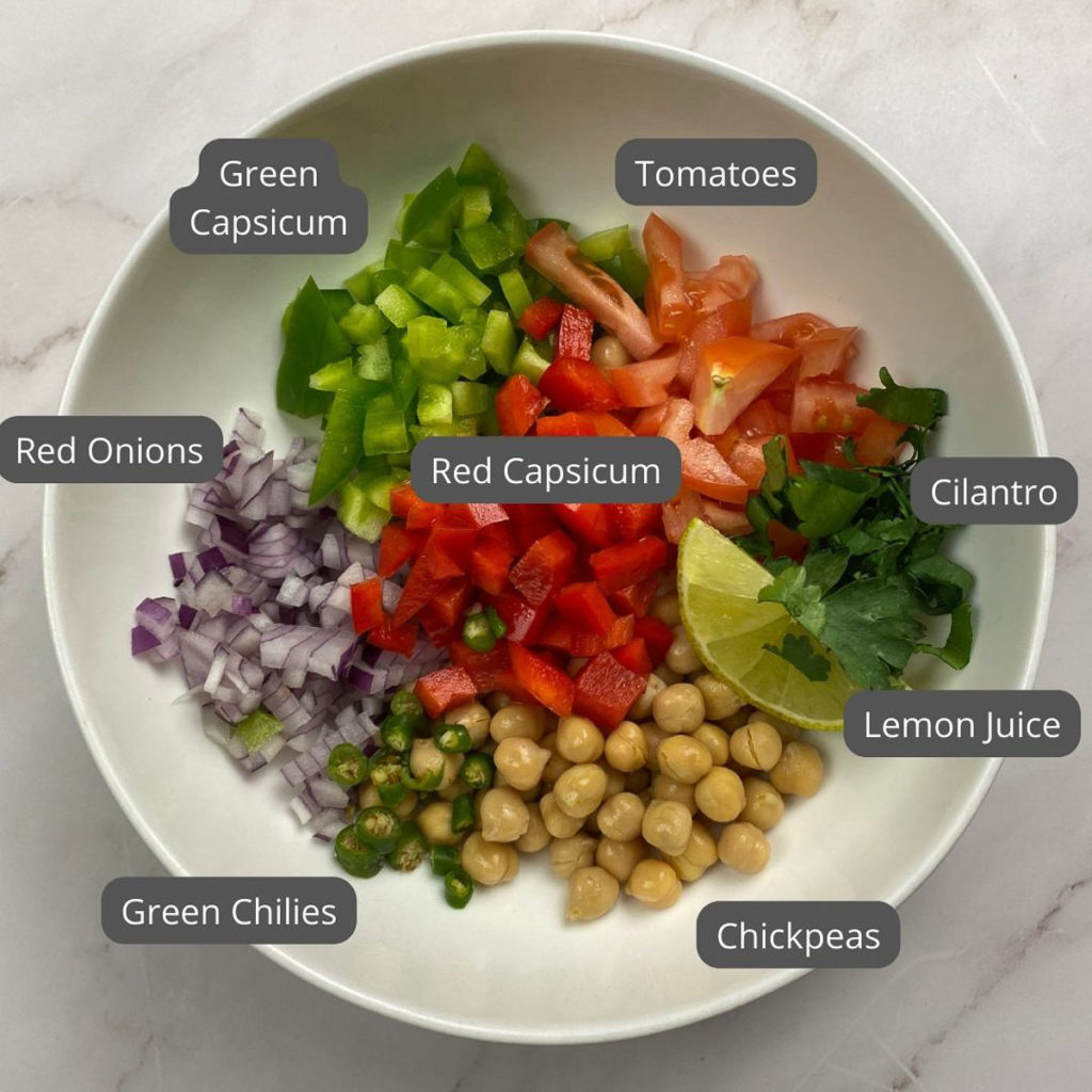 Indian Chickpea Salad - Bowl with chickpeas, tomatoes, red capsicum, red onions, green chilies