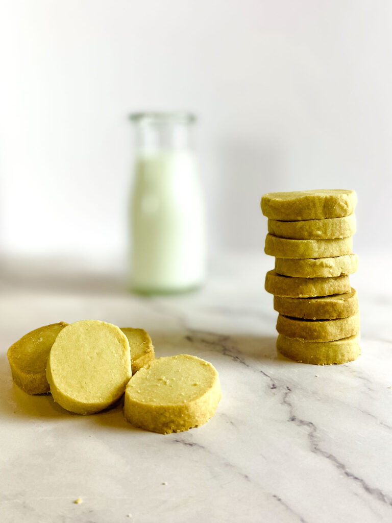 3 Ingredient Brown Sugar Cookies - Stacked with a bottle of milk