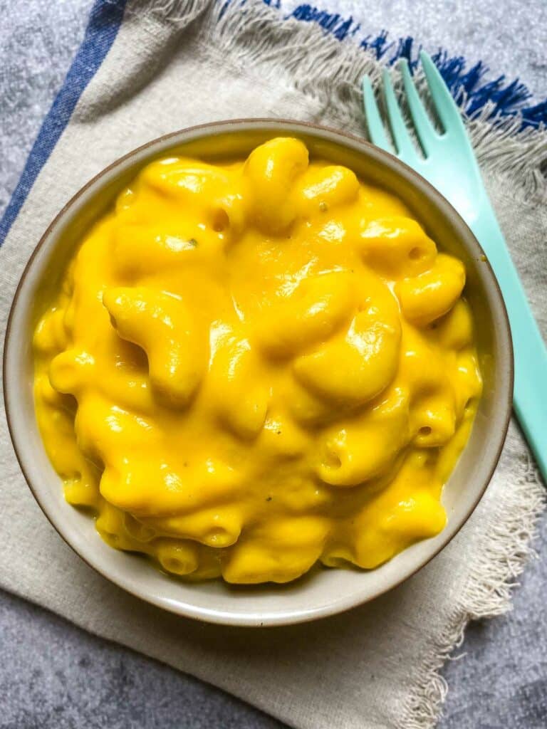 Hidden Vegetable Mac And Cheese in a bowl with a fork.toddler mac and cheese