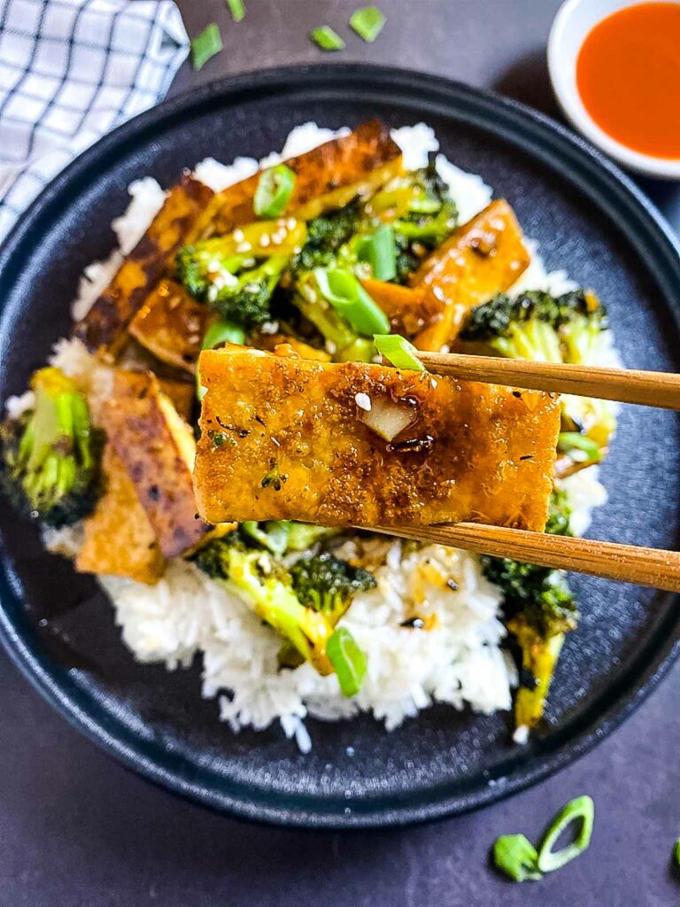 Mongolian Crispy Tofu And Broccoli Stir Fry picked up by chopsticks
