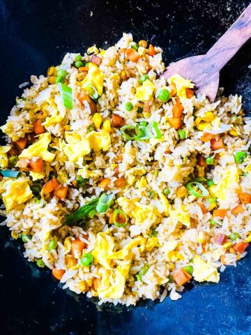 Fried Rice With Frozen Vegetables in Wok WIth Wooden Spoon