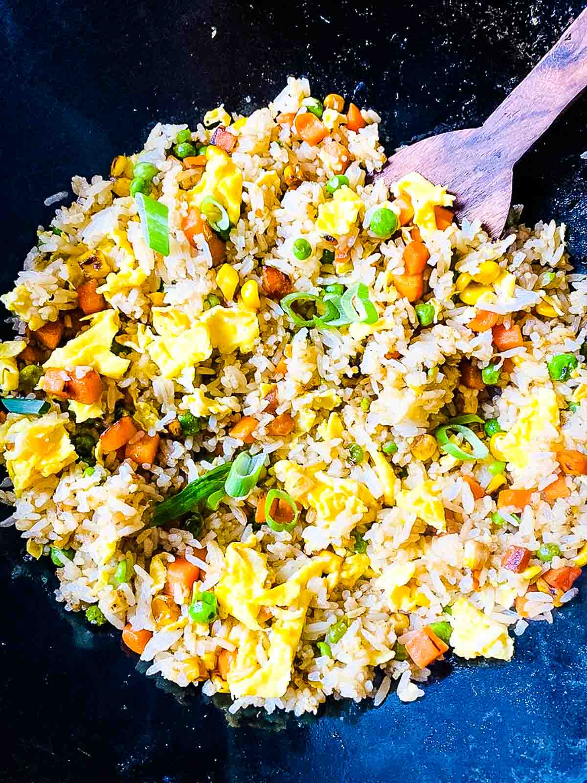 Fried Rice With Frozen Vegetables in Wok WIth Wooden Spoon