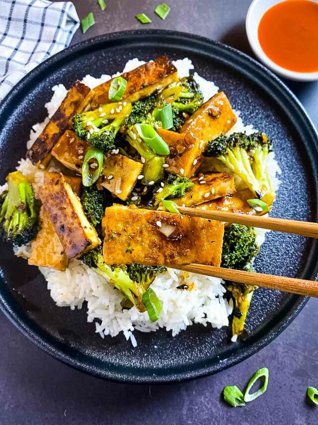 Mongolian Tofu served over rice and picked with chopsticks