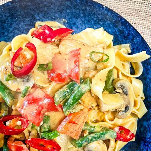 Pasta in Thai curry in a bowl.