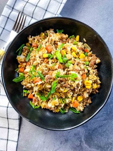 Fried rice in a bowl with napkin on side.