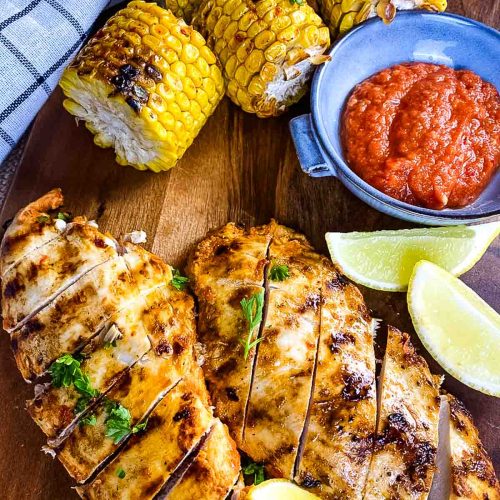 Chicken breast, corn cobs, peri peri sauce and lemon wedges.