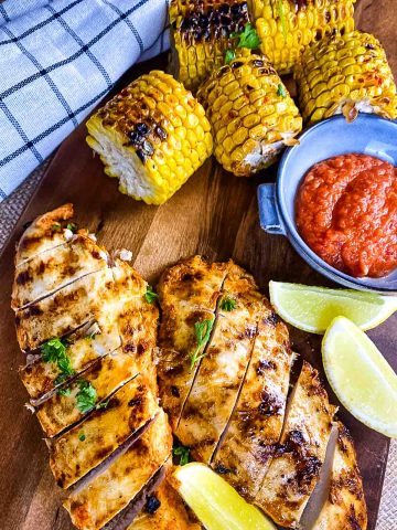 Chicken breast, corn cobs, lemon wedges, peri peri sauce.