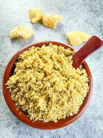 Pork rinds in a bowl with spoon.