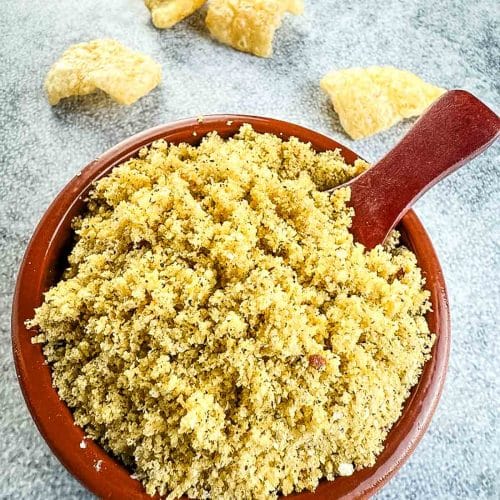 Pork rinds in a bowl with spoon.