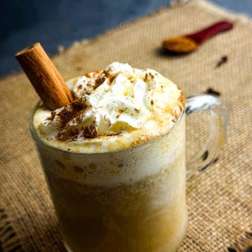 Pumpkin spice latte in a cup with whipped cream.